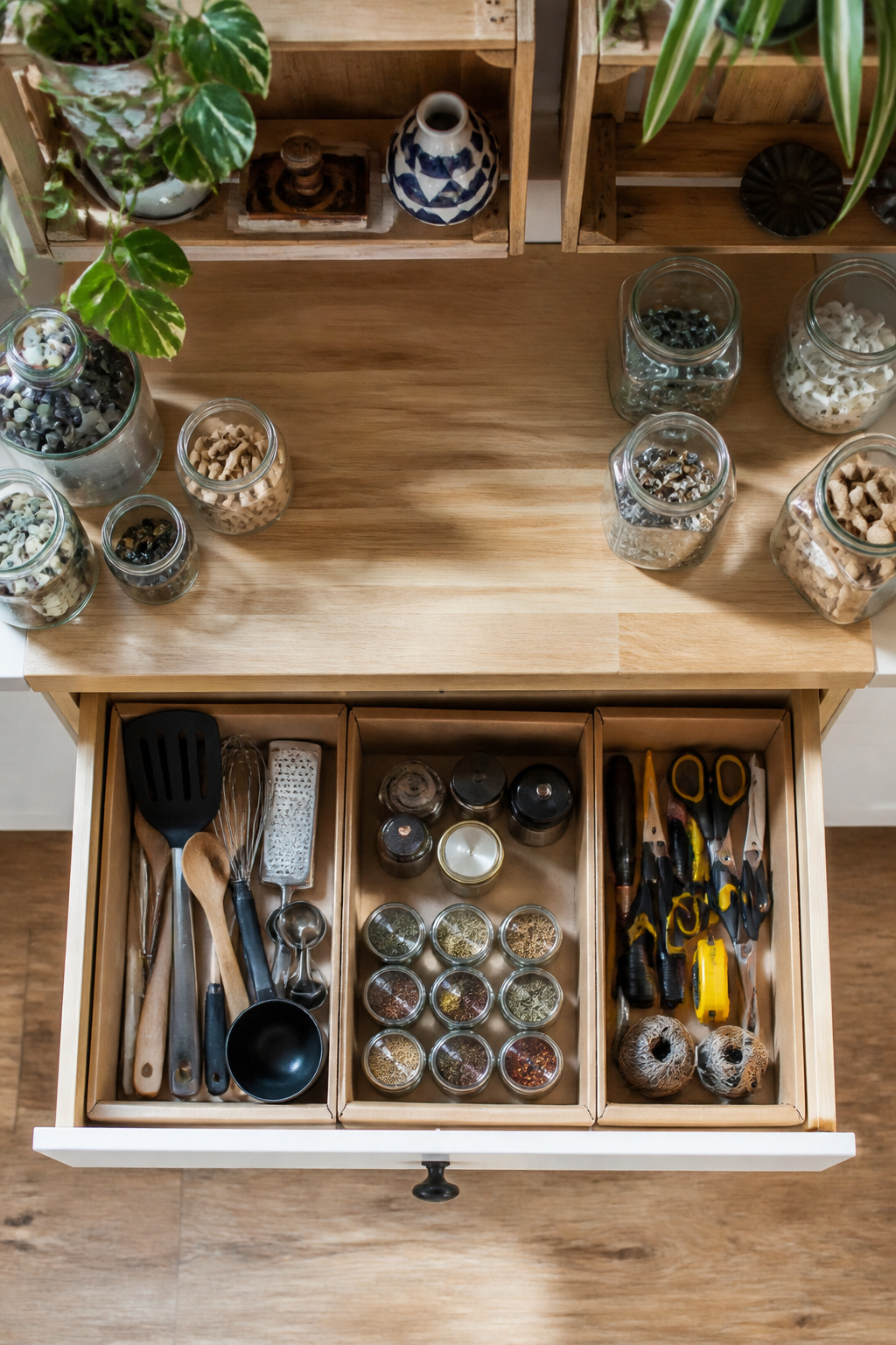 Custom drawer dividers made from cardboard in a kitchen drawer.