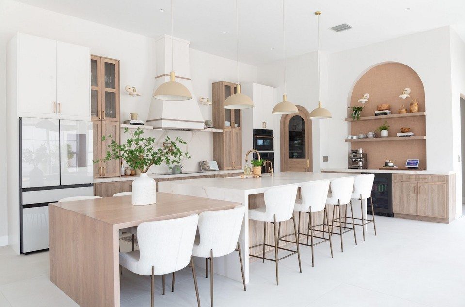 Large white kitchen island with bar stools and a wooden dining extension.
