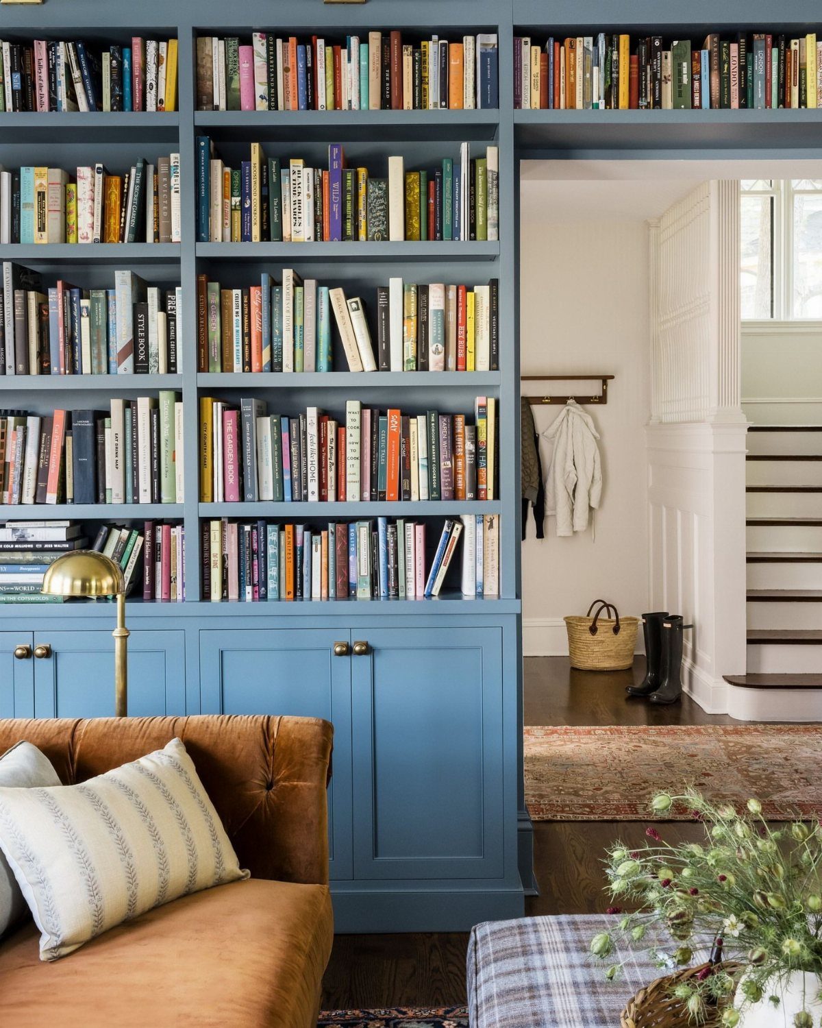 Living Room Storage Cabinet Ideas: 14 Styles That Fit Any Space 4 Blue built-in bookcase filled with books above matching cabinets in a living room.