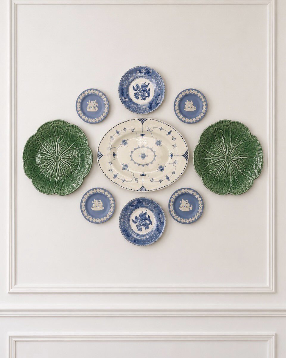 Vintage Plate Set Ideas: 12 Timeless Styles for Your Table 6 Decorative ceramic plates including green cabbage plates and blue patterned plates on a wall.