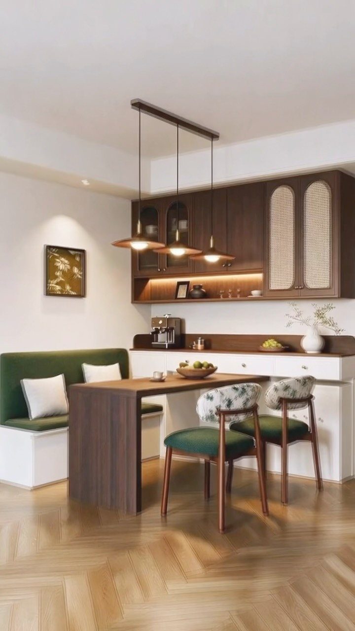 Dark wood dining table with green banquette seating and matching chairs in a kitchen.