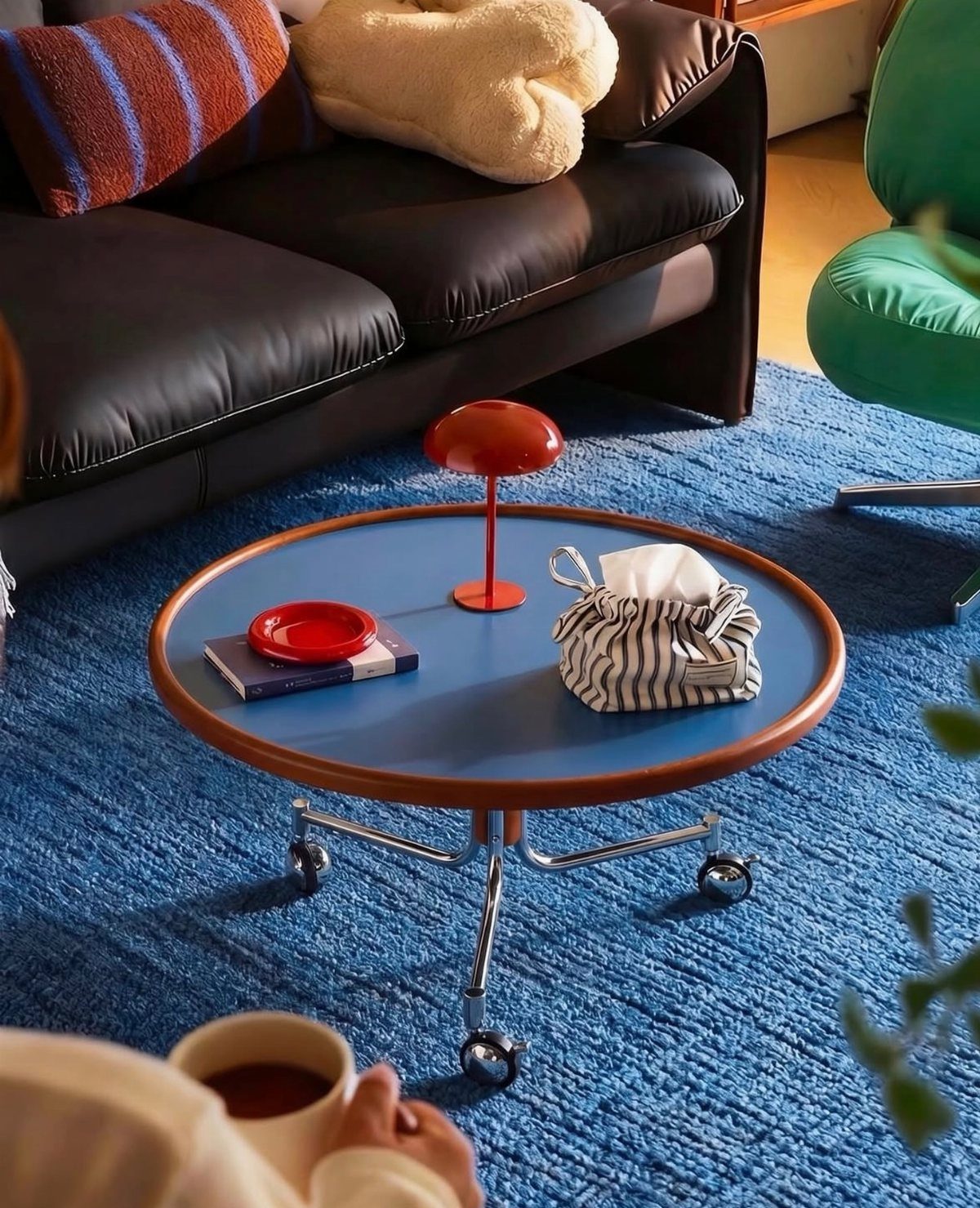 Furniture on Wheels: 19 Ideas for Rolling Pieces That Move 6 Round blue coffee table with chrome legs and wheels on a blue rug.