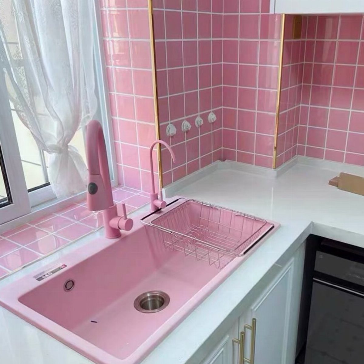 Small Kitchen Sink Ideas: 26 Ways to Maximize Space and Style 16 Pink kitchen sink with matching pink faucet and drying rack against pink tiles.