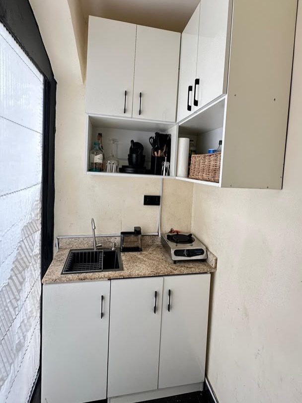 Small Kitchen Sink Ideas: 26 Ways to Maximize Space and Style 24 Small stainless steel kitchen sink installed in a compact white kitchenette with granite countertops.