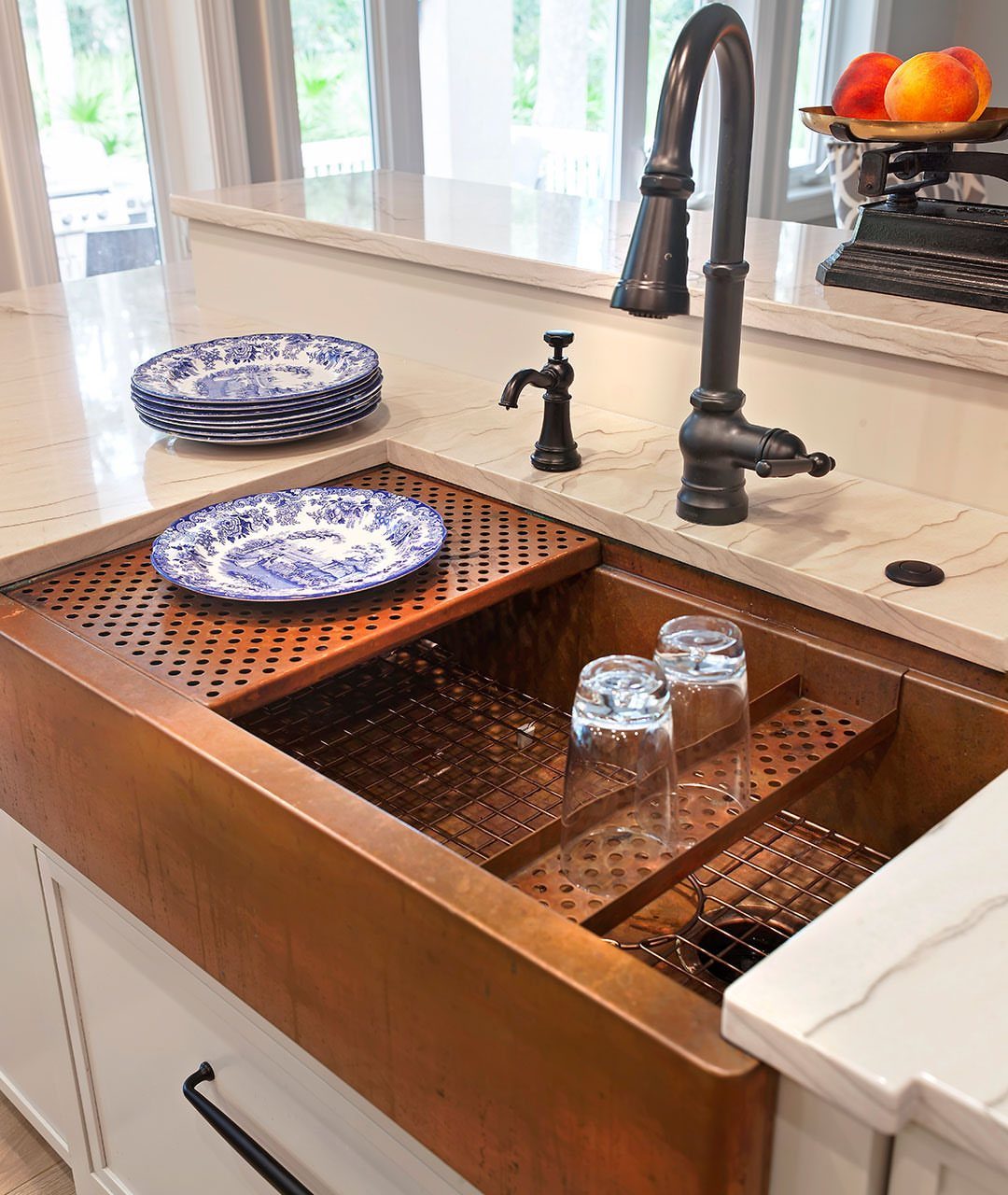 Small Kitchen Sink Ideas: 26 Ways to Maximize Space and Style 18 Copper farmhouse sink with dark bronze faucet and blue patterned plates on white countertop