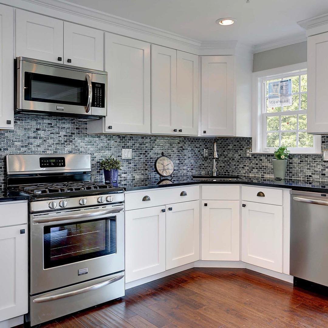 Small Kitchen Sink Ideas: 26 Ways to Maximize Space and Style 9 Corner sink in a small kitchen with white cabinets and grey mosaic backsplash.