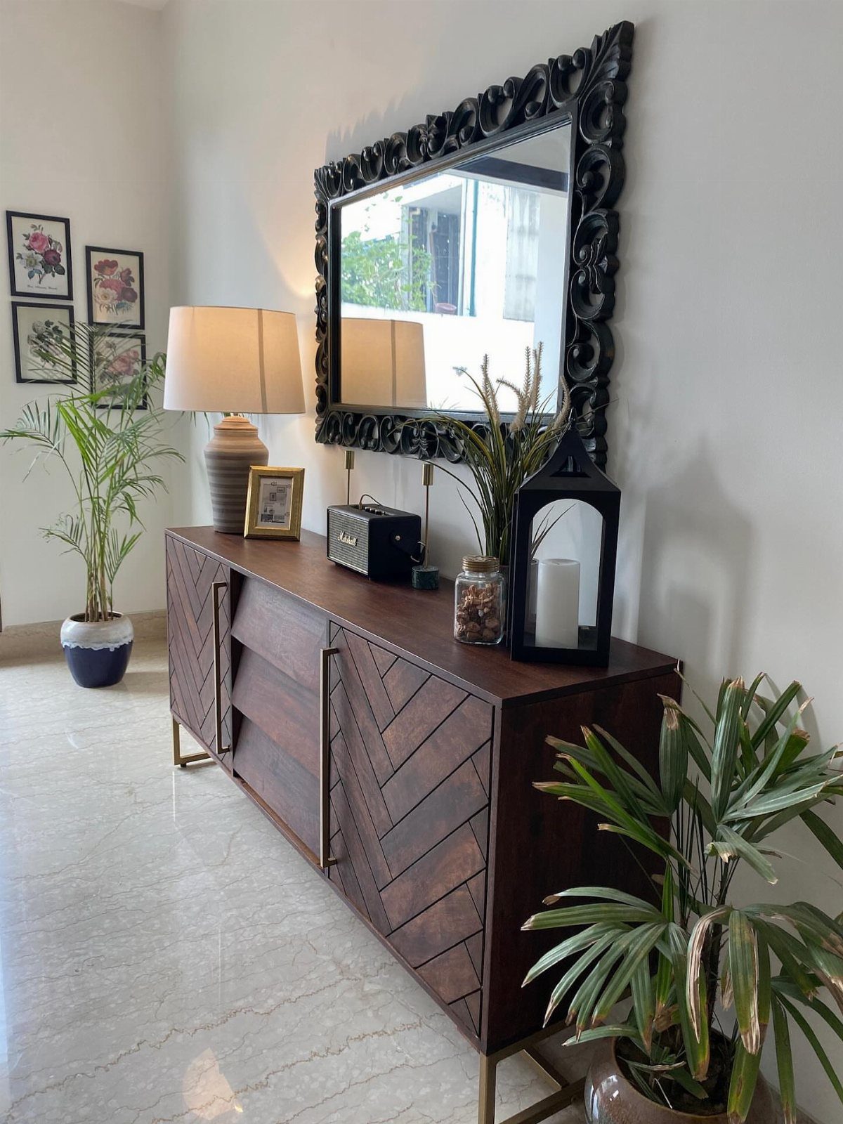 Dining Room Armoire: 16 Ideas for Storage and Style 5 Dark wood sideboard with chevron pattern under a large ornate black wall mirror.