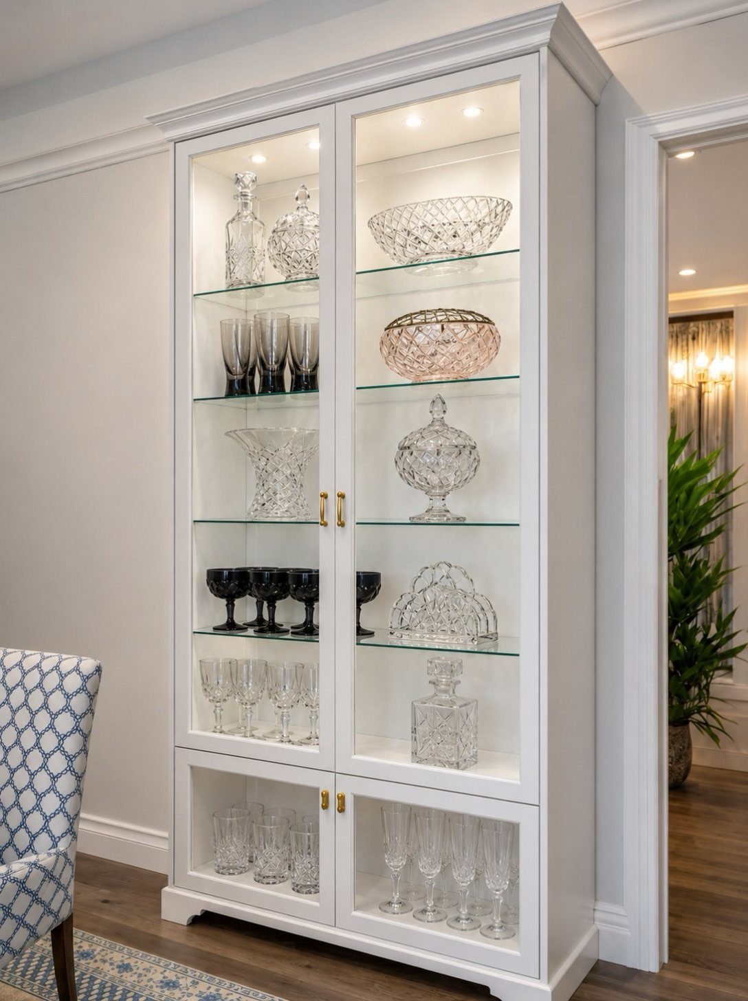 Dining Room Armoire: 16 Ideas for Storage and Style 2 White glass-door display cabinet with interior lighting showcasing crystal glassware and bowls.