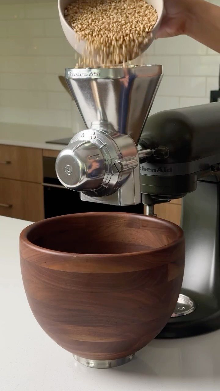 Green KitchenAid with Wood Bowl in 10 Kitchen Settings 6 Dark green KitchenAid mixer with grain mill attachment and a polished wood bowl.