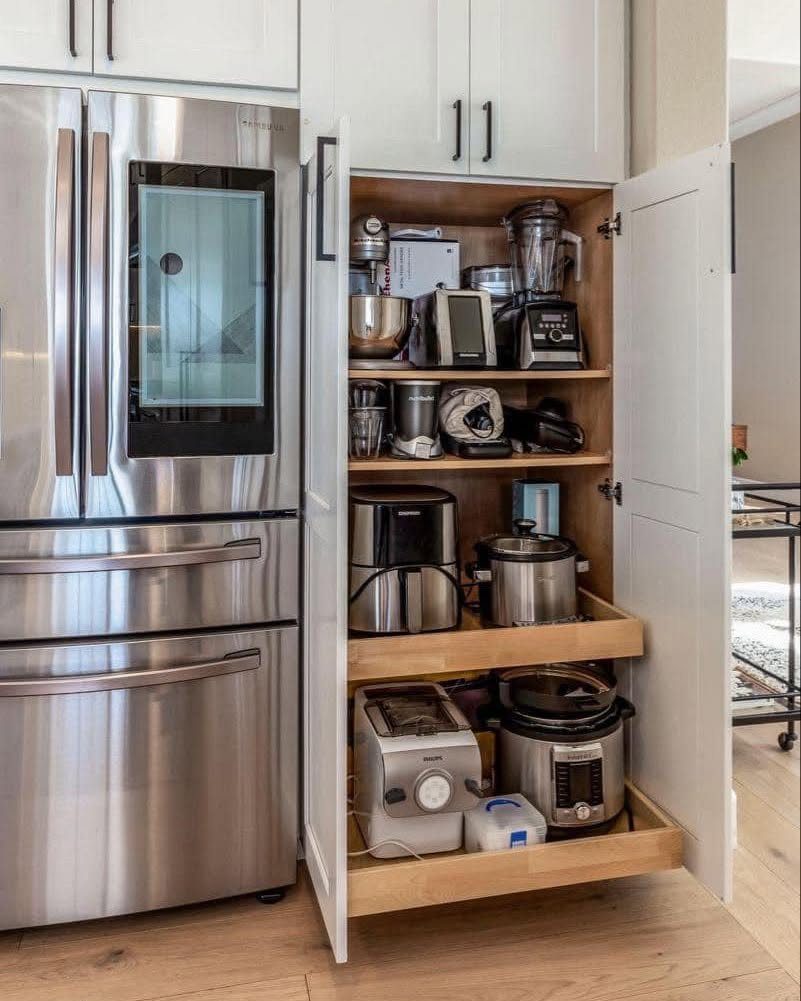 Nigerian Kitchen Design: 25 Ideas for Modern Functional Spaces 25 White kitchen cabinet with pull-out shelves storing various small kitchen appliances.