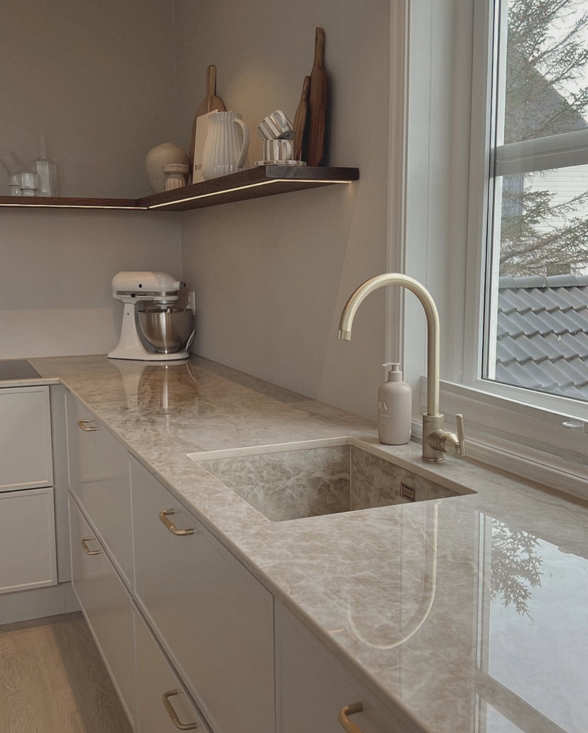 Small Kitchen Sink Ideas: 26 Ways to Maximize Space and Style 14 Integrated stone sink with gold faucet set in a marbled kitchen countertop.