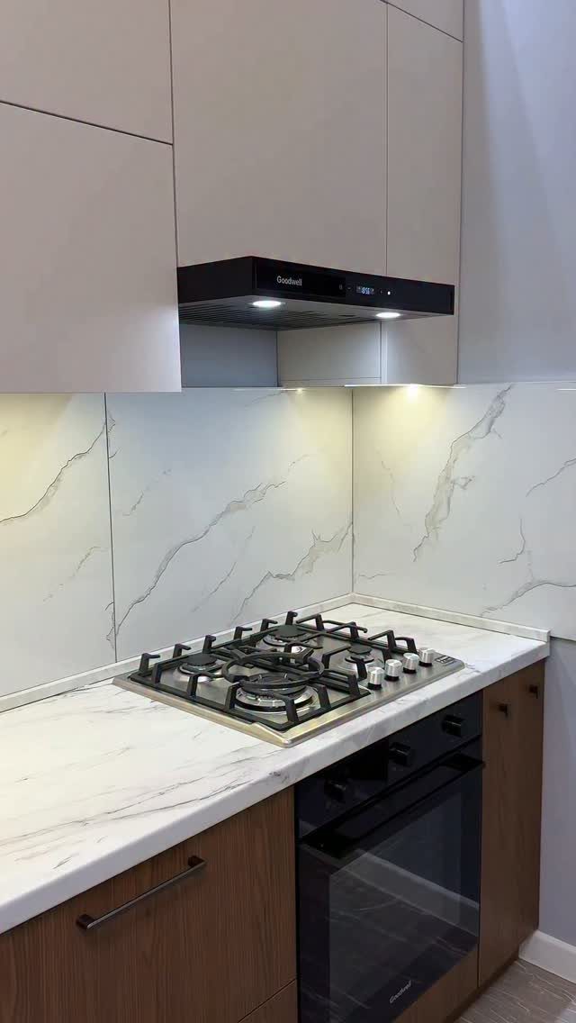 L Shaped Kitchen Cabinets: 24 Ideas for Style and Function 12 Black range hood vent installed above a gas stovetop in a modern kitchen.