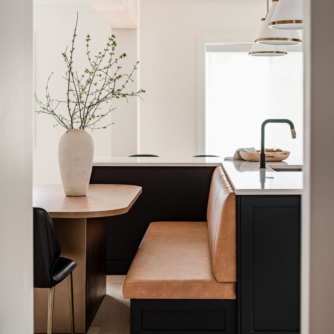 L Shaped Kitchen Cabinets: 24 Ideas for Style and Function 23 Black L-shaped kitchen cabinets with a white countertop and tan leather banquette seating.