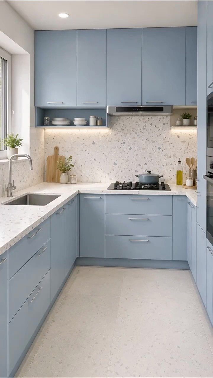 L Shaped Kitchen Cabinets: 24 Ideas for Style and Function 17 Light blue L-shaped kitchen cabinets with white countertops and a speckled backsplash.