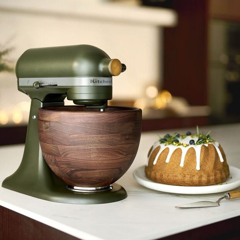 Green KitchenAid with Wood Bowl in 10 Kitchen Settings 8 Olive green KitchenAid stand mixer with a wooden bowl and a glazed cake.