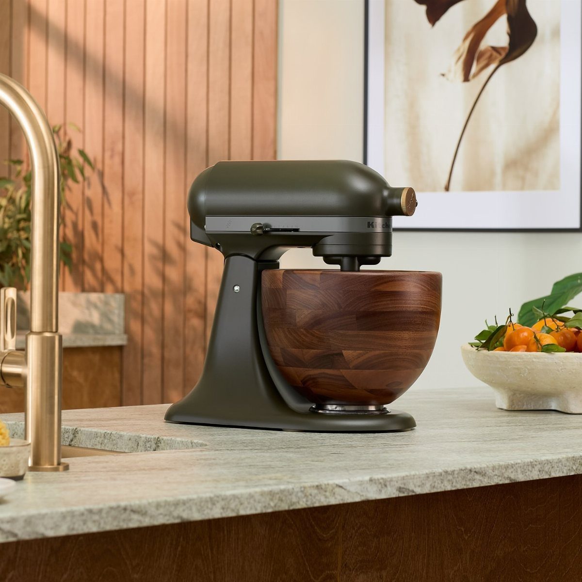 Green KitchenAid with Wood Bowl in 10 Kitchen Settings 11 Olive green KitchenAid stand mixer with a polished wood bowl on a grey countertop.