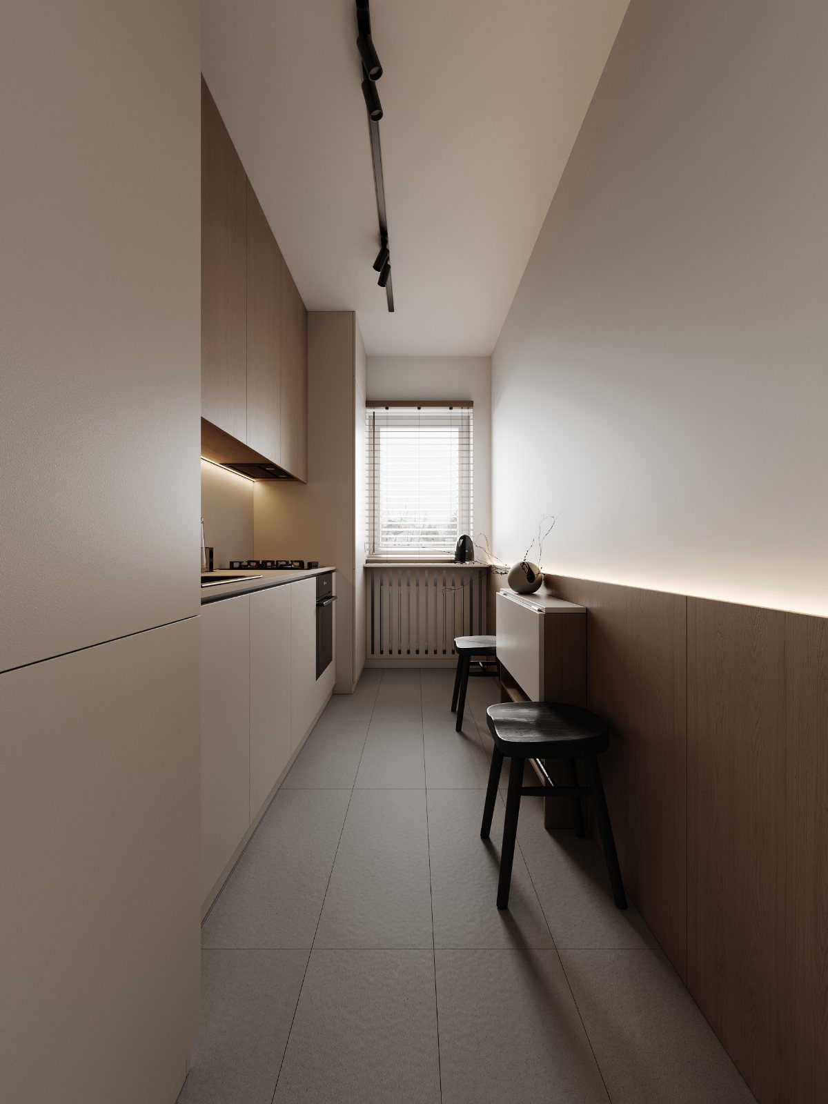 Narrow modern galley kitchen with white cabinets, light wood accents and black stools.