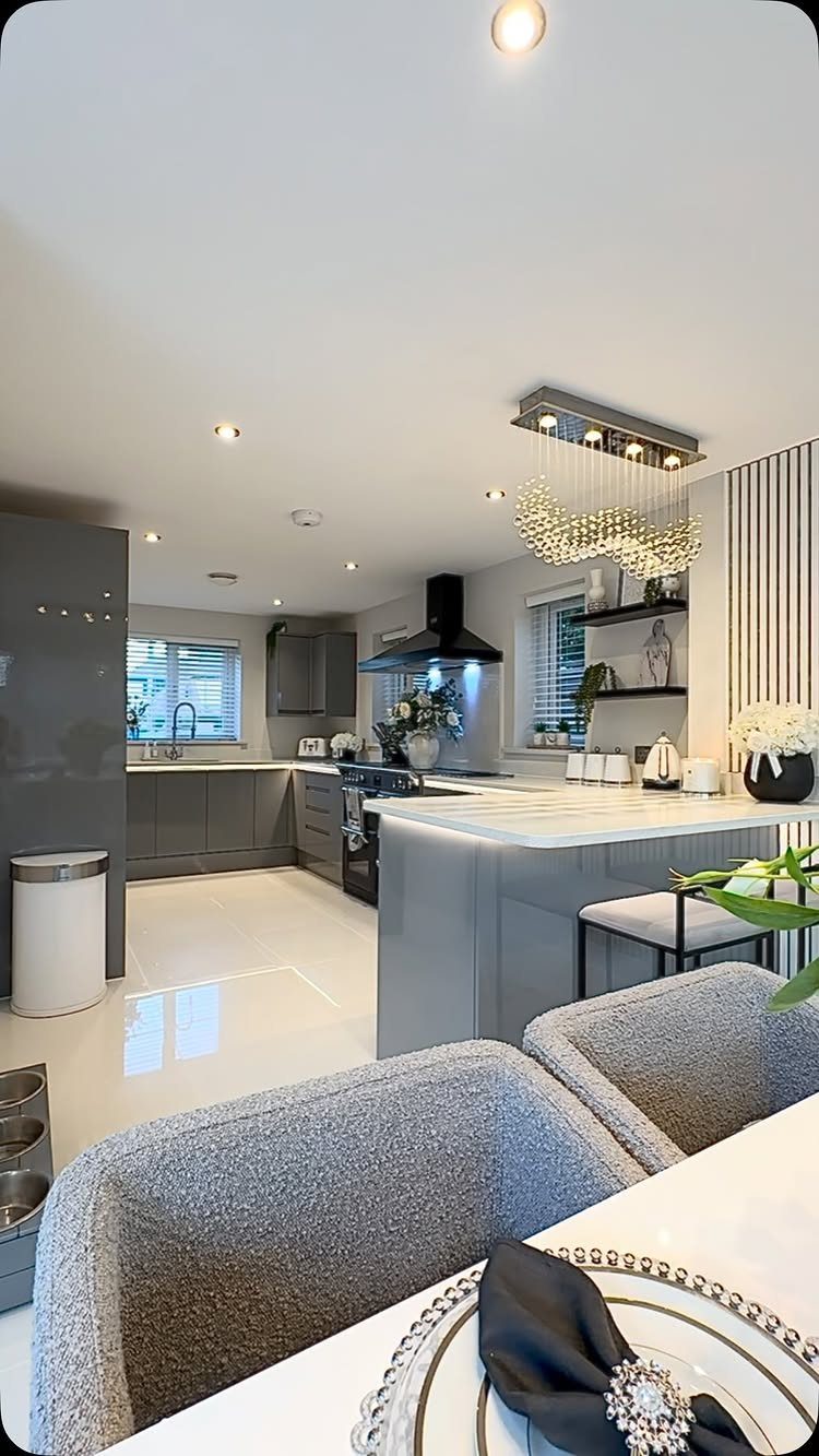 L Shaped Kitchen Cabinets: 24 Ideas for Style and Function 4 Modern grey kitchen with an island and dining area in an open-plan layout.