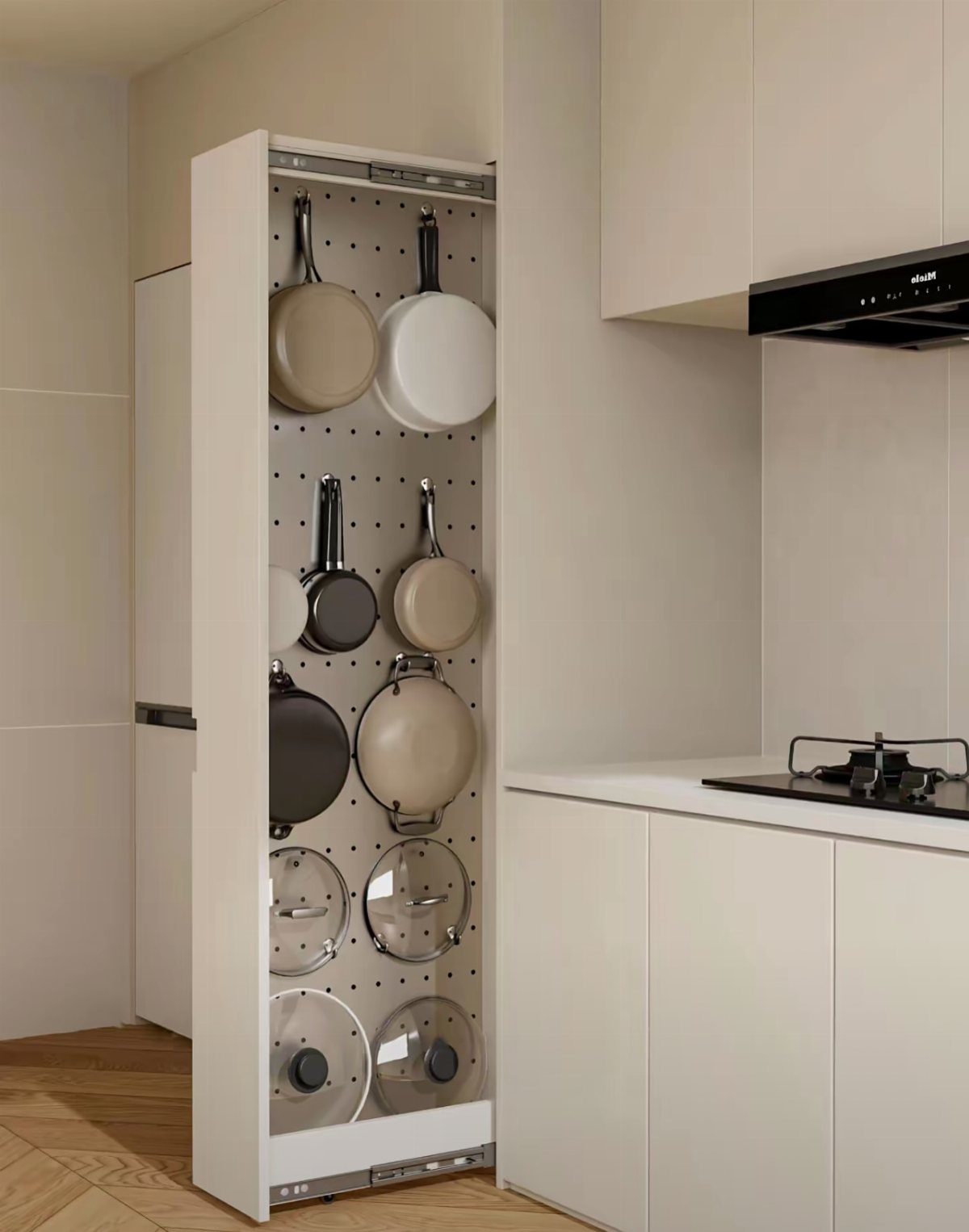 Pull-out kitchen cabinet organizer holding frying pans and glass lids on a pegboard.