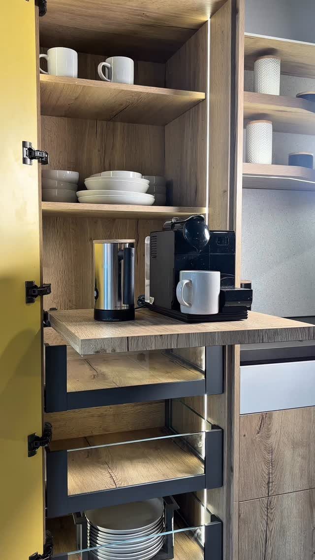 Hidden Coffee Bar Cabinet: 17 Ideas for Every Style 3 Pull-out wooden shelf in a cabinet holding a coffee machine and milk frother.