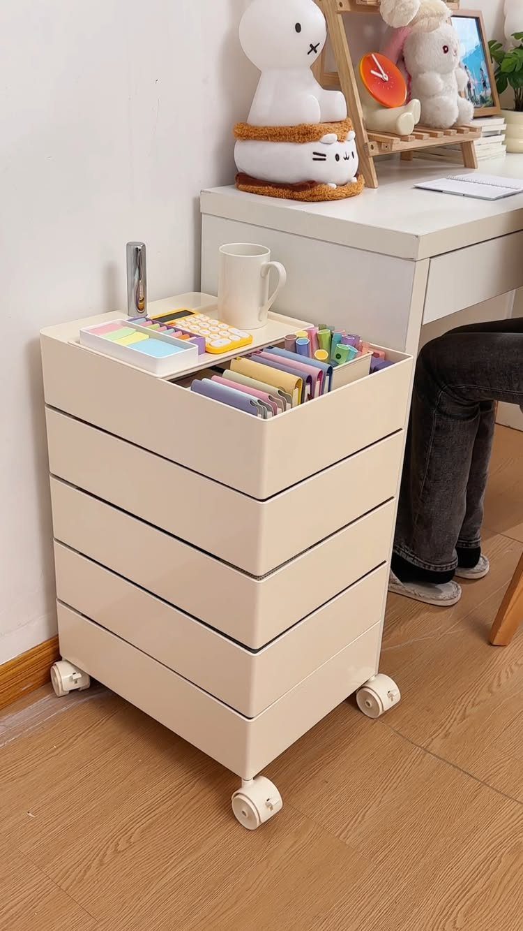 Furniture on Wheels: 19 Ideas for Rolling Pieces That Move 11 White plastic storage drawer unit with caster wheels next to a white desk.