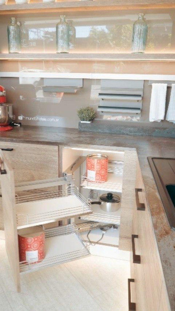 Nigerian Kitchen Design: 25 Ideas for Modern Functional Spaces 23 Rotating wire corner shelves inside a light wood kitchen cabinet holding kitchenware