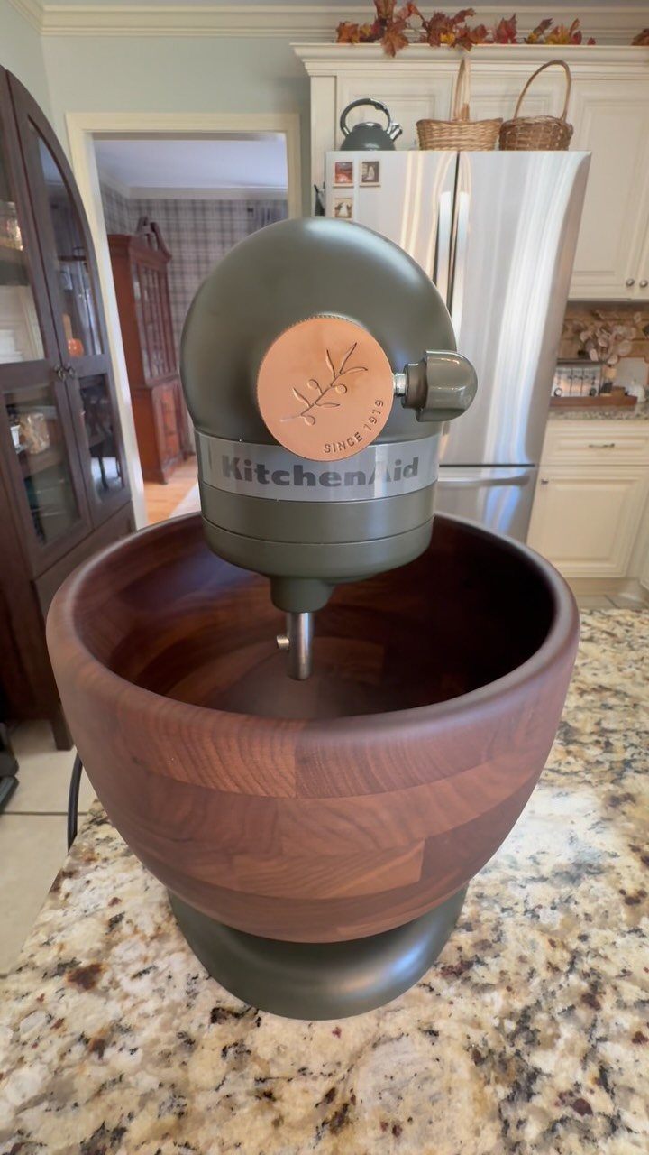 Green KitchenAid with Wood Bowl in 10 Kitchen Settings 7 Sage green KitchenAid stand mixer with a large polished wooden mixing bowl.