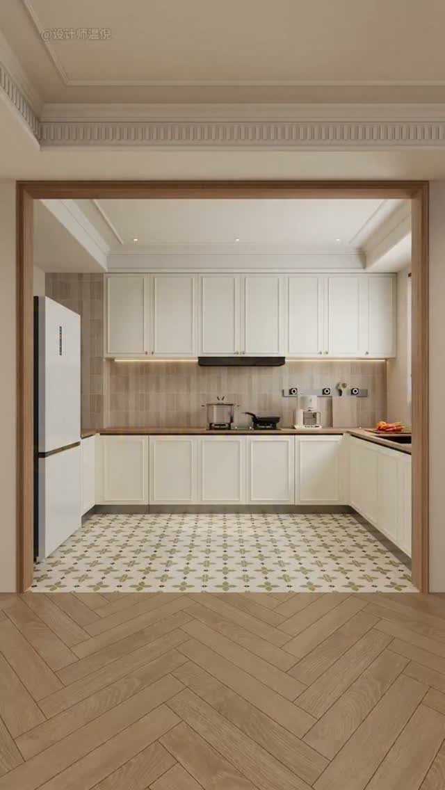 White shaker style kitchen cabinets with patterned tile flooring and herringbone wood floors.