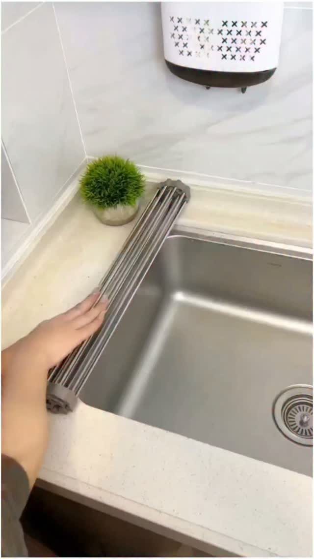 Small Kitchen Sink Ideas: 26 Ways to Maximize Space and Style 27 Stainless steel kitchen sink with a grey roll-up drying rack being positioned across it.