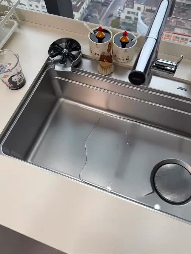 Small Kitchen Sink Ideas: 26 Ways to Maximize Space and Style 3 Stainless steel single-bowl kitchen sink with chrome faucet and light-colored countertop.