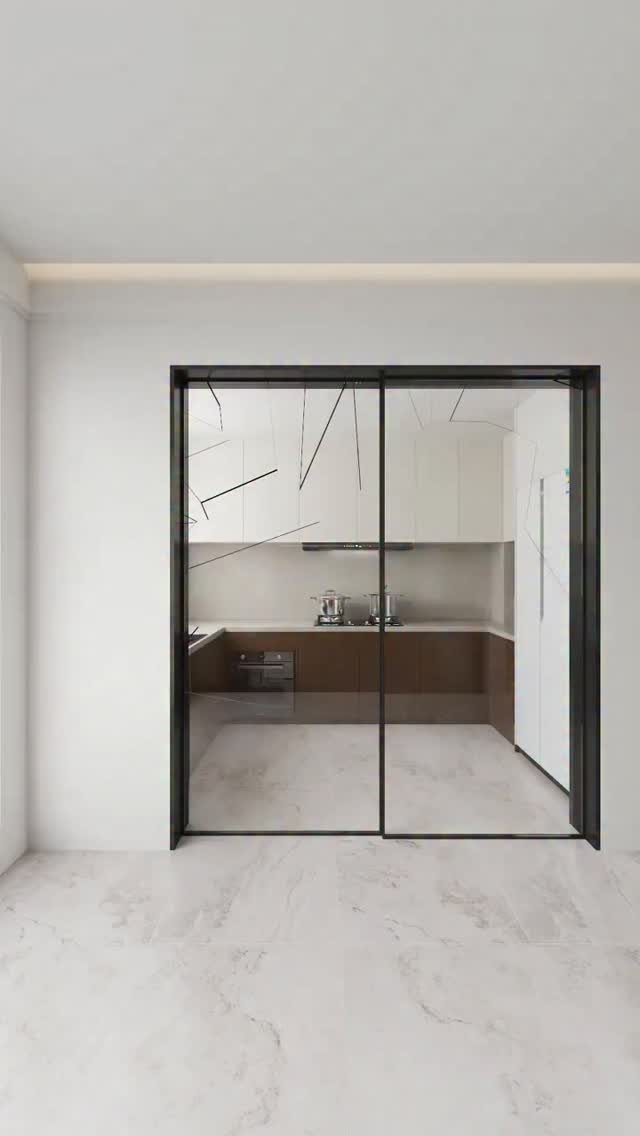 Modern kitchen with white and brown cabinets seen through glass sliding doors.