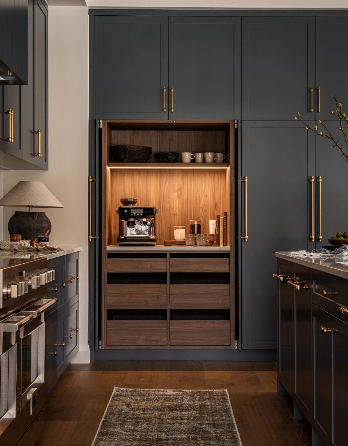 Hidden Coffee Bar Cabinet: 17 Ideas for Every Style 14 Wood-lined coffee station recessed into dark grey kitchen cabinetry with gold hardware.