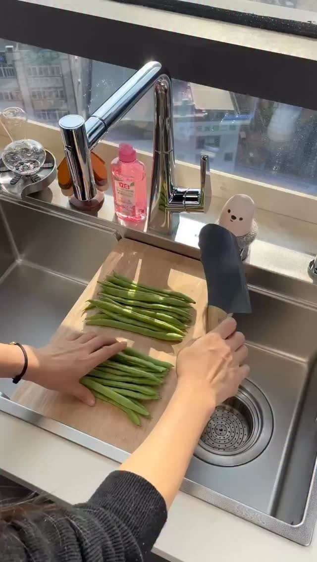 Small Kitchen Sink Ideas: 26 Ways to Maximize Space and Style 6 Person chopping green beans on a wooden board inside a workstation kitchen sink.